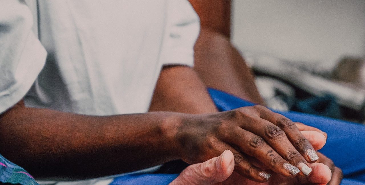 A volunteer holding hands with a patient